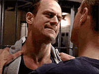 a man is holding another man 's neck while another man looks on .