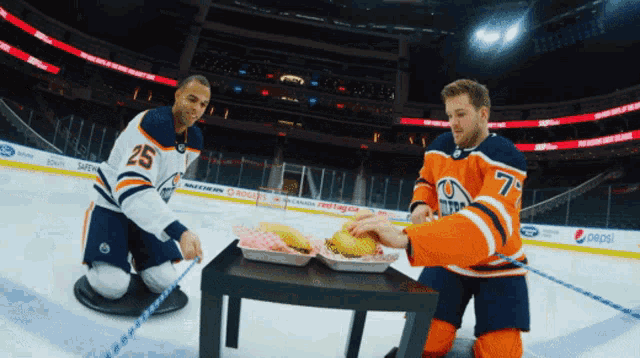 two hockey players on the ice with one wearing a number 25 jersey