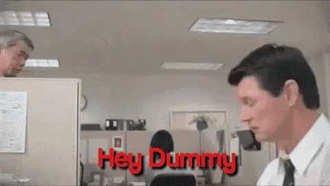 a man in an office cubicle says " hey dummy " to another man
