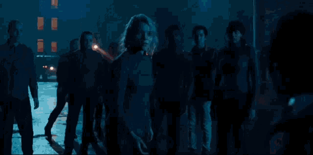 a group of people are running in a dark street and the word run is visible
