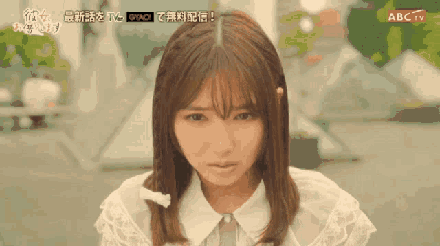 a close up of a woman 's face with abc tv in the upper right corner