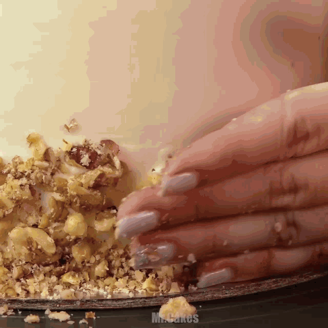 a close up of a person 's hand on a cake that says mr cakes