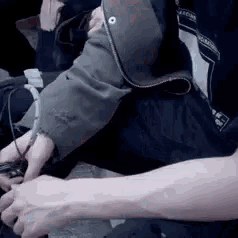 a close up of a person 's arm holding a video game controller .