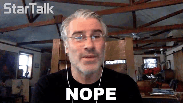 a man wearing ear buds and a black shirt says nope