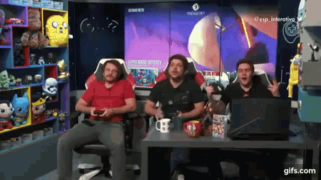 a group of men are playing a video game in front of a screen that says esp interactivo