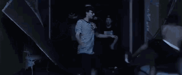 a group of people are dancing in a dark room in a club .