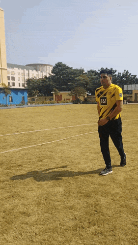 a man in a yellow and black jersey with the number 181 on it