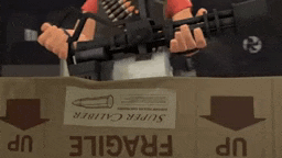 a person is holding a gun in front of a box that says fragile on it