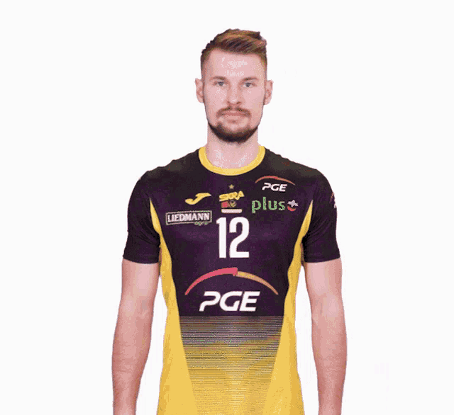 a man is wearing a purple and yellow shirt with the number 12 on it