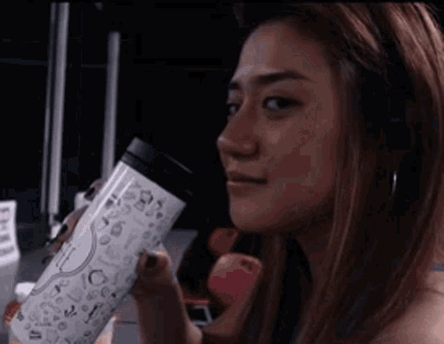 a woman is holding a coffee mug that says ' i love you '