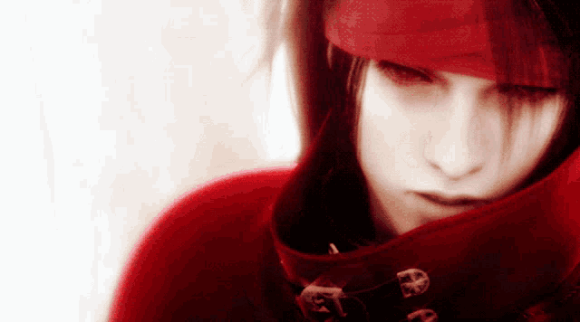 a close up of a person 's face with a red hat on