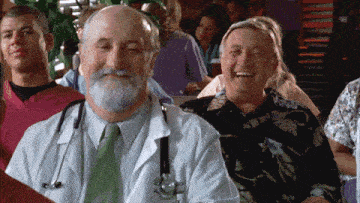 a doctor with a stethoscope around his neck is laughing