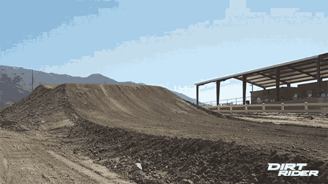dirt rider shows a dirt track and a building