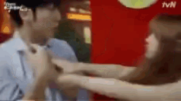 a man and a woman are sitting at a table with their arms around each other .