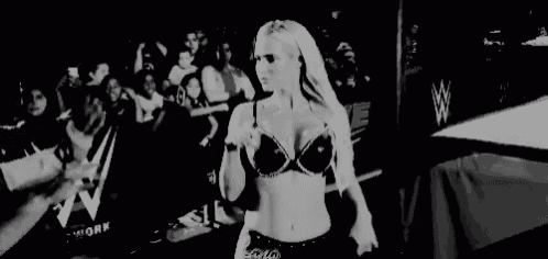 a black and white photo of a woman in a bra dancing .