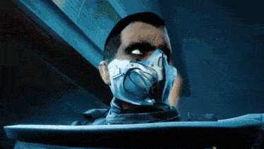 a man with a mask on his face is looking at something .