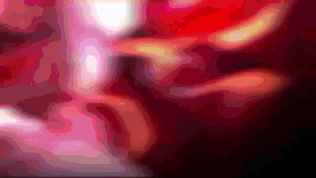 a close up of a red and pink background