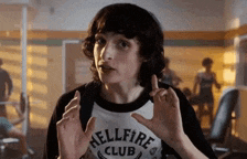 a young man wearing a shirt that says hellfire club