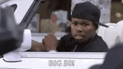 a man in a hat is sitting in the driver 's seat of a car and talking to another man .