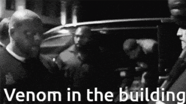 a black and white photo with the words venom in the building on the bottom