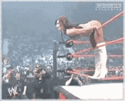 a woman in a wrestling ring with the word exclusive on the bottom right