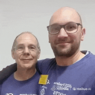 two men are posing for a picture with one wearing a blue shirt that says hailuo ai