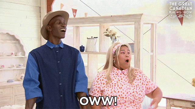 a man and a woman are standing next to each other and one of them is saying oww
