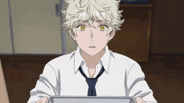 a boy in a white shirt and tie is holding a tray