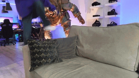 a statue of a man is standing on a couch in a room