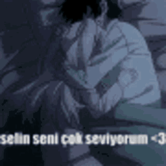 a man and a woman are hugging each other in a dark room with the words i love you in the background .