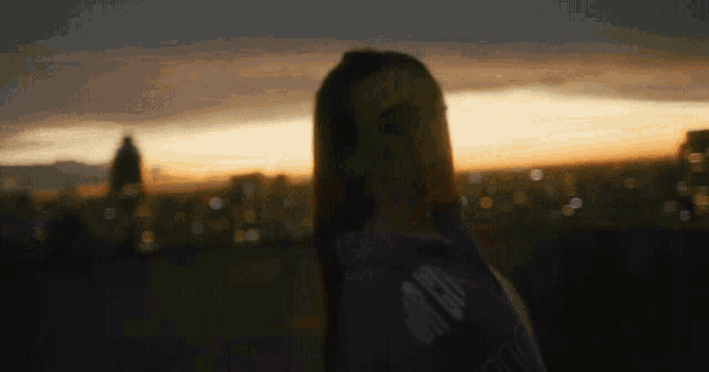 a woman wearing a purple sweatshirt with the word aa on it