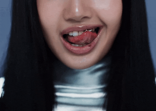 a close up of a woman with her tongue out