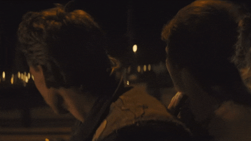 a man and a woman are hugging in the dark