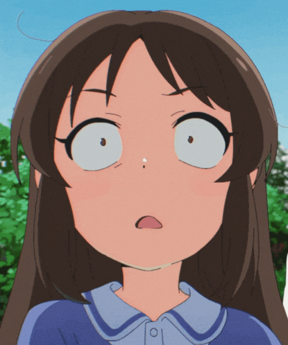 a close up of a girl 's face with a blue shirt on
