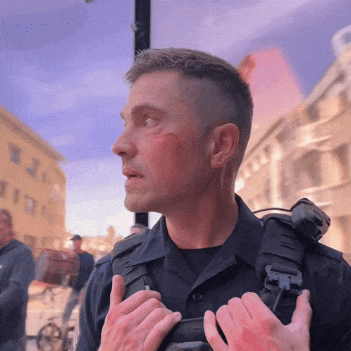 a police officer with a red spot on his forehead