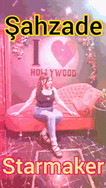 a woman sits on a couch in front of a sign that says i hollywood