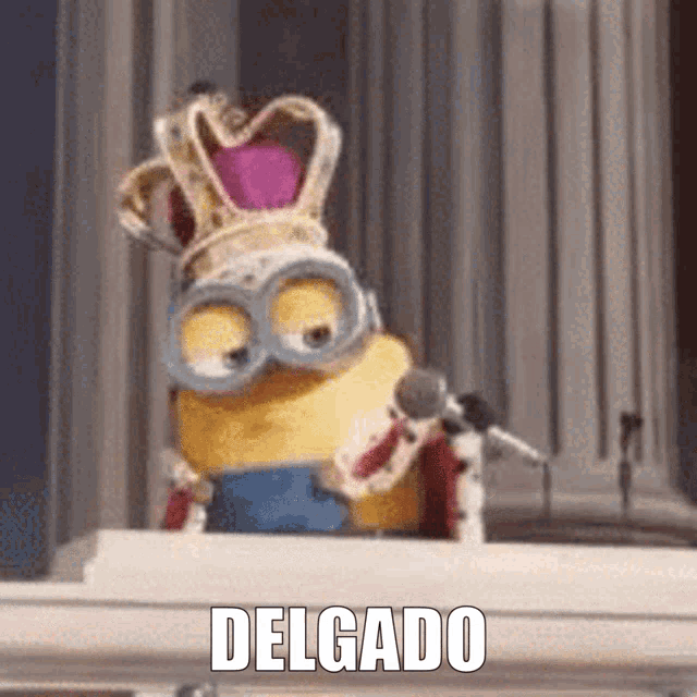 a minion wearing a crown and goggles is sitting at a podium with the word delgado written below him