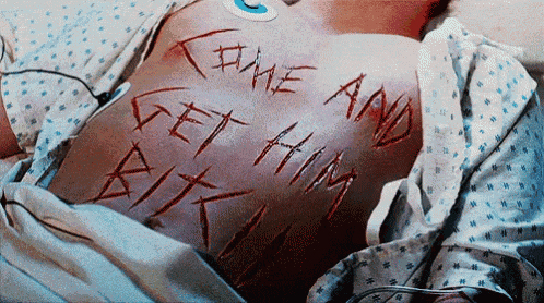 a person in a hospital bed has the words " come and get him " written on their back