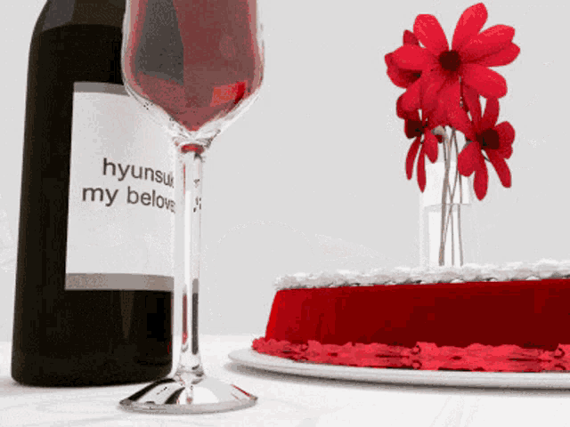 a bottle of hyunsui my belove wine sits next to a glass