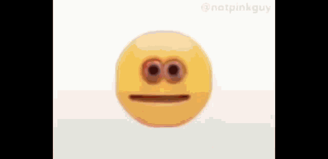 a yellow smiley face with two eyes and a mouth is sitting on a white table .