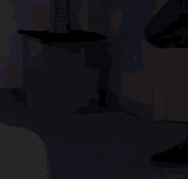 a person squatting down with their legs crossed in a room