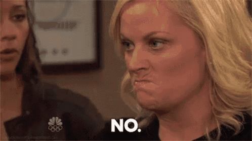 a woman is making a face and says no .