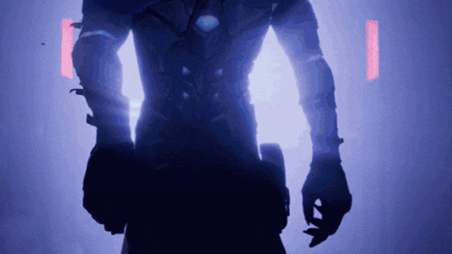a silhouette of a person in a dark room with a purple light behind them