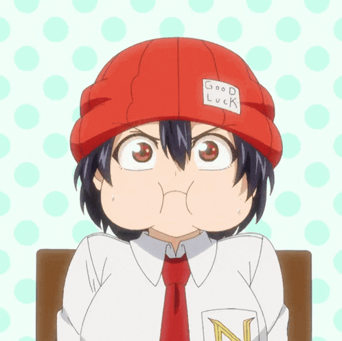 a person wearing a red hat with the word good luck on it