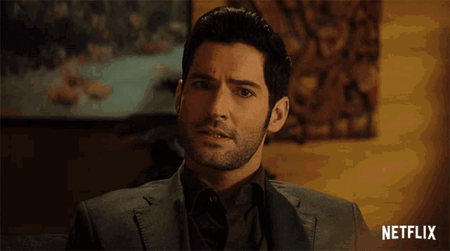 a man in a suit with a netflix logo on the bottom
