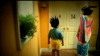 a woman and a child are standing in front of a door that says 14
