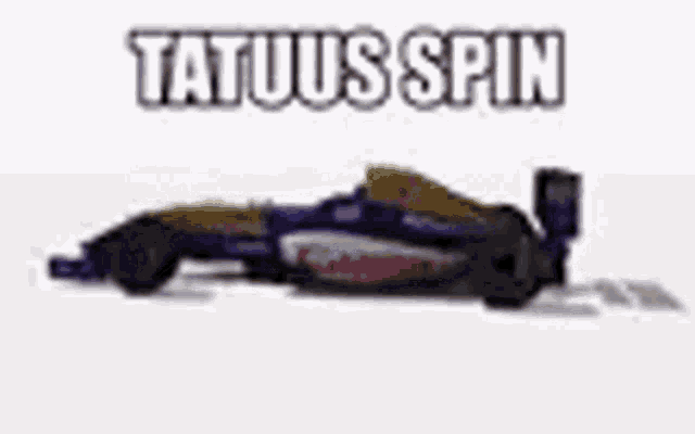 a toy race car is sitting on a white surface with the words tatuus spin above it .