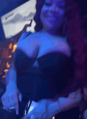 a woman with red hair and a black top is dancing