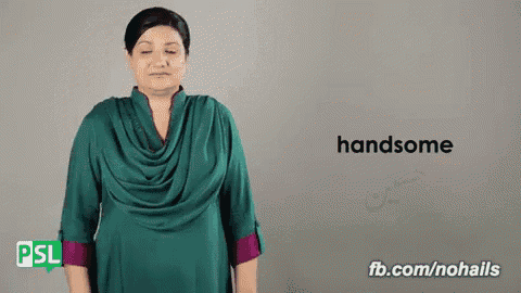 a woman in a green dress is making a gesture that says handsome