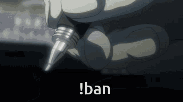 a close up of a person holding a pen with the word ban on the bottom